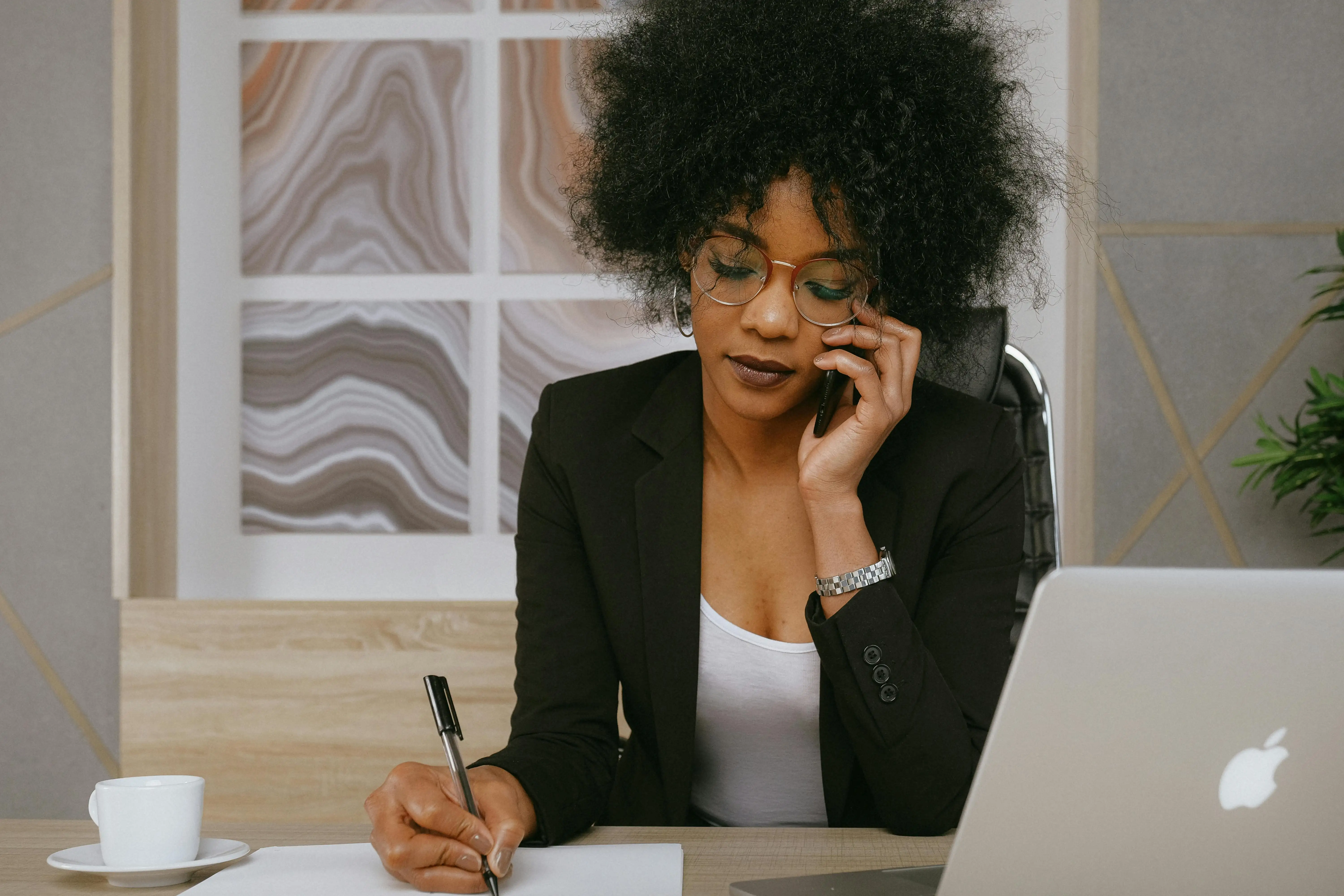 Woman on the phone taking notes